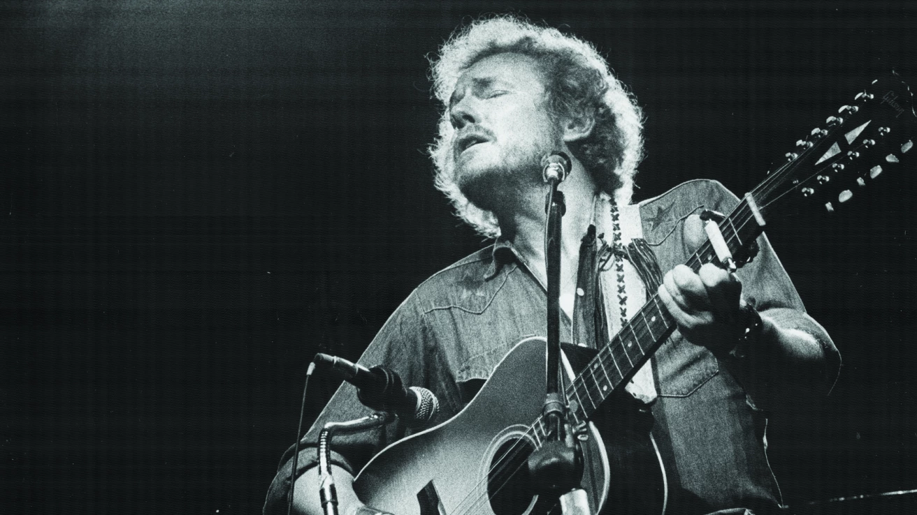 Gordon Lightfoot performing with his acoustic guitar in the 1970s